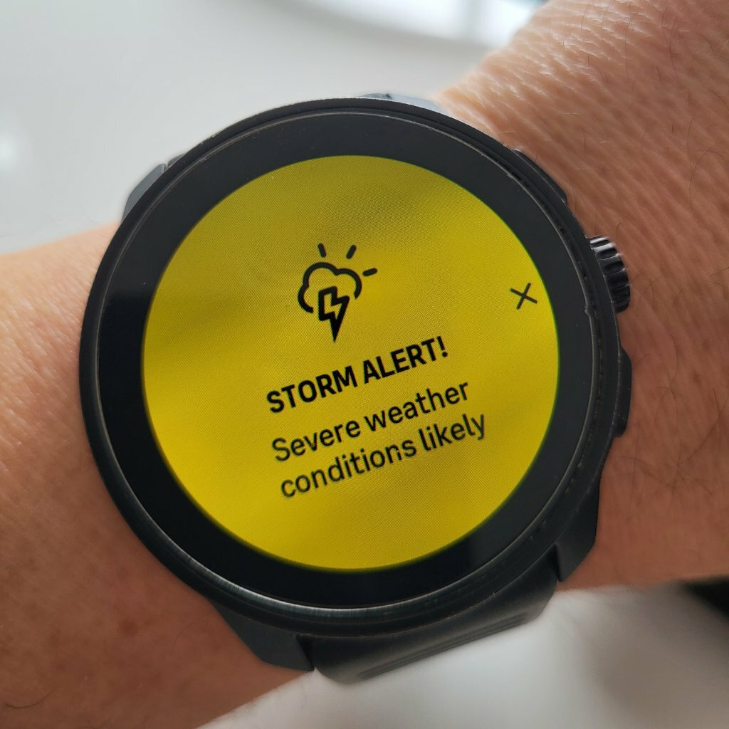 A smartwatch displays a storm alert for severe weather conditions.